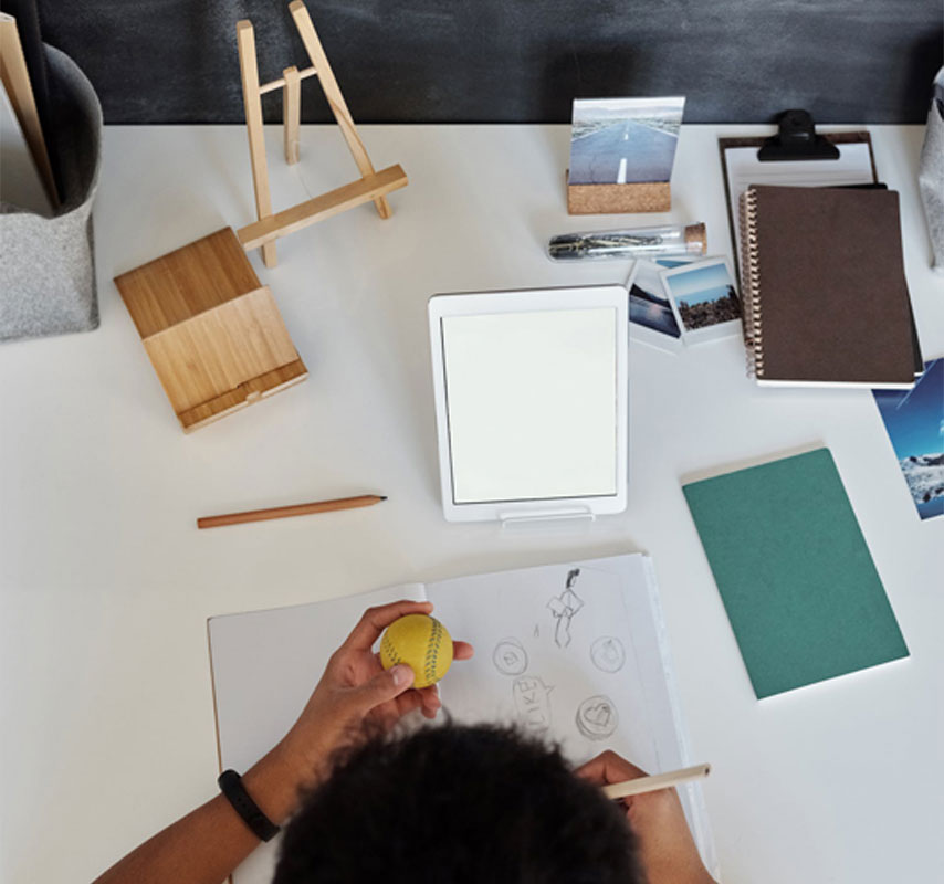 Boy engaged in the engineering design process. Sketching a ball.
