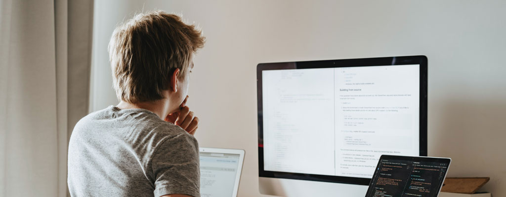 Young Man Thinking at Computer