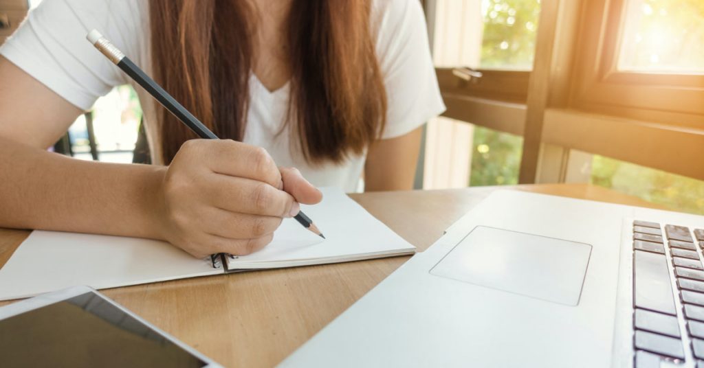 Student Writing a Reflective Paragraph. Photo by Tirachard Kumtanom @ pexels.com